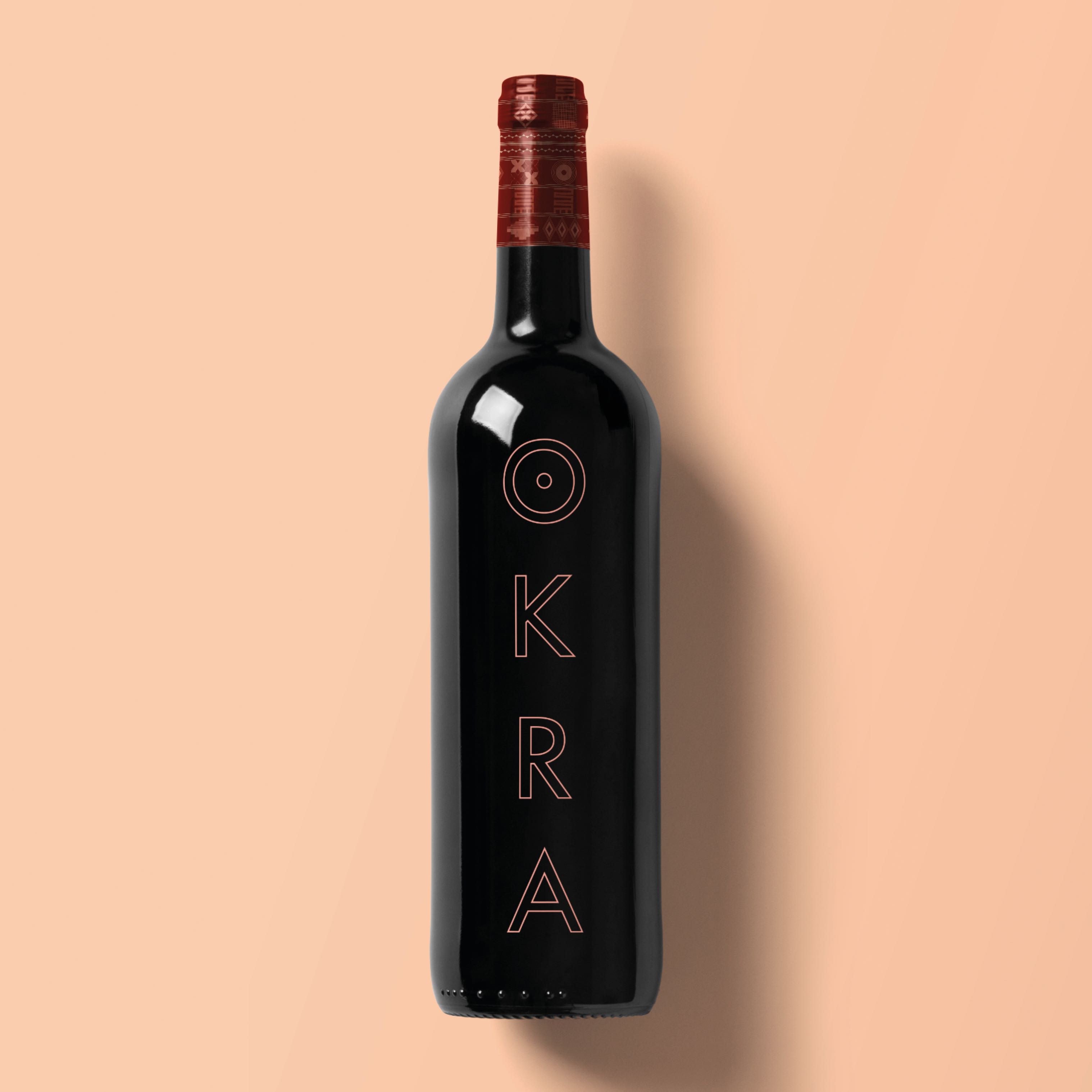a wine bottle that has the okra logo and a patterned top